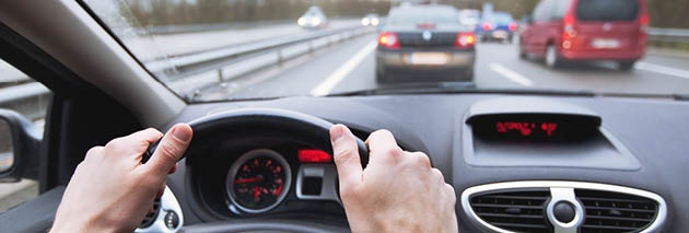 driving car on highway, close up of hands on steering wheel