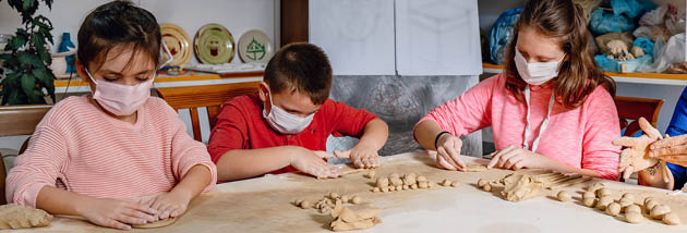 children learn to make clay vases